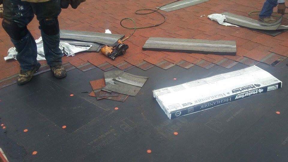 A worker installing new roof shingles with a nail gun for Villalobos Remodeling & Construction in El Paso, TX