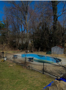 A worker carefully installing a new pool liner as part of a renovation by CDO Pool & Hot Tub Renovation in Norwalk, CT.