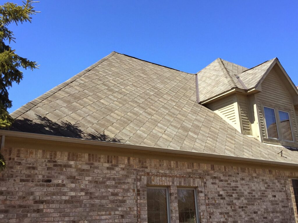 A worker installing new roof shingles for Sherriff-Goslin Roofing Contractors in Flint, MI