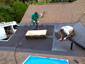 A worker installing shingles during a roof repair performed by Venerable Construction Service Group, LLC in Bowie, MD.