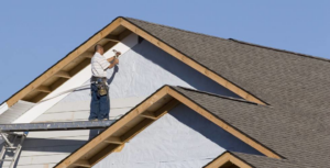 A construction worker installing siding on a new house build by JON Construction, Inc. in Allentown, PA.