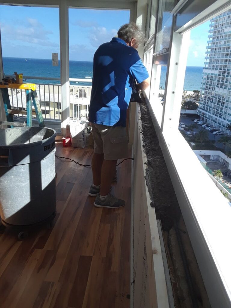 A construction worker installing a window frame or railing by Corley Construction Inc in Fort Lauderdale, FL
