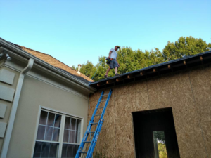 A worker on a roof during new construction or addition work by Rampro Construction in Rock Hill, SC