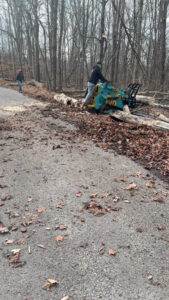 A worker operating a log processor on a dirt road, provided by Juarez Tree Service in Bawcomville, LA.