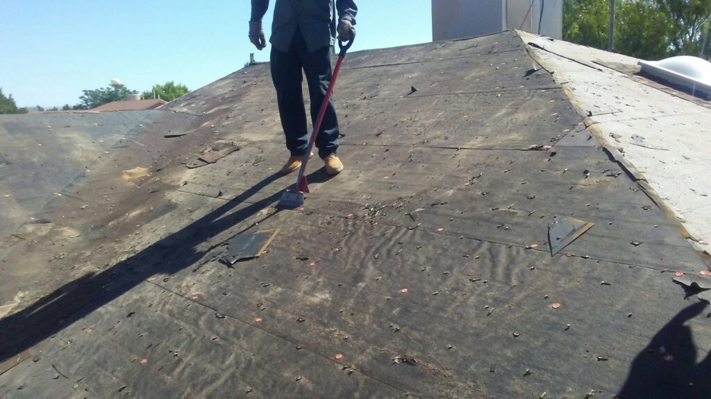 A worker preparing a roof for new shingle installation by Villalobos Remodeling & Construction in El Paso, TX