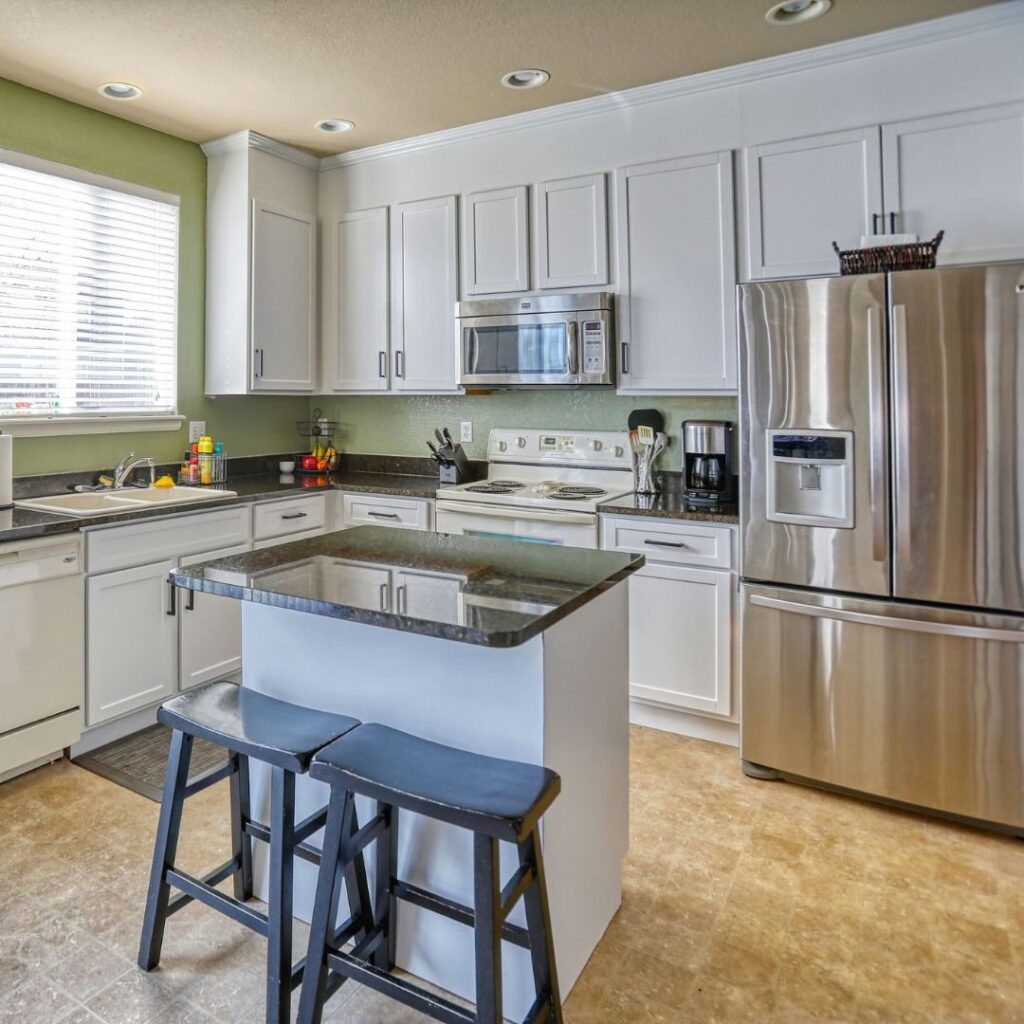 A worker sealing around newly installed windows during a project by FHIA Remodeling in Fort Lauderdale, FL