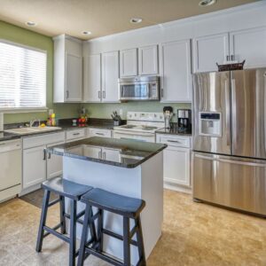 A worker sealing around newly installed windows during a project by FHIA Remodeling in Fort Lauderdale, FL