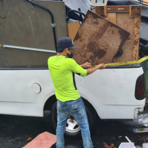 Worker securing junk in a truck for removal by Trash Removal Junk Removal Hauling & Donation Moma Services, Baltimore, MD.