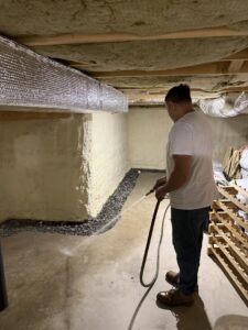 A worker from B-Dry System of New England testing a newly installed basement drainage system with water in North Billerica, MA.