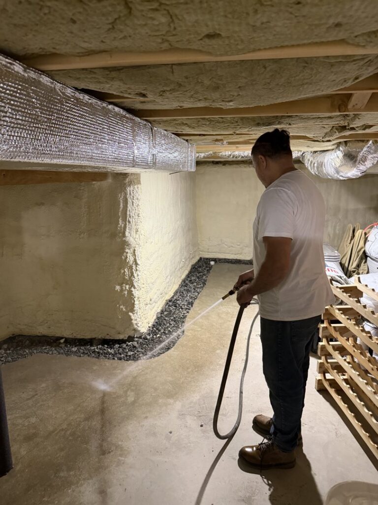 A worker from B-Dry System of New England testing a newly installed basement drainage system with water in North Billerica, MA.