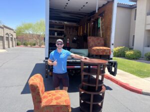A Happy Hippo Junk Removal worker with furniture ready for pickup in Scottsdale, AZ.