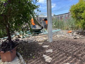 Workers from Impact Environmental Co. demolishing an old structure in a backyard in El Cajon, CA.