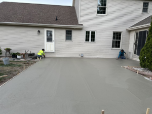 Workers finishing a newly poured concrete patio for a home by R&A Concrete Home Solutions LLC in Appleton, WI.
