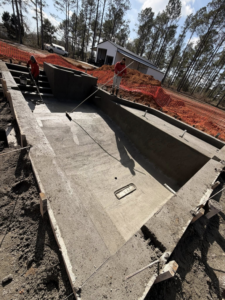 Workers finishing the concrete interior of a new pool shell for Ga Impact Shotcrete in Atlanta, GA.