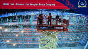 Workers on a scissor lift installing commercial chain link fencing inside a large warehouse for Memphis Fence Company, LLC in Memphis, TN.