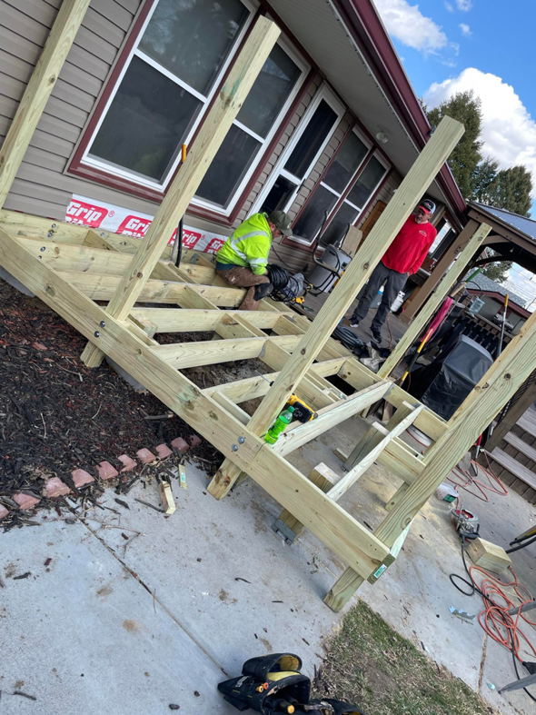 Workers installing the wooden structure for a new outdoor deck by B&B Handyman Solutions in Omaha, NE.