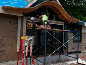 GT Building Corp. handymen installing exterior siding and trim on a home in Hudson, MA.