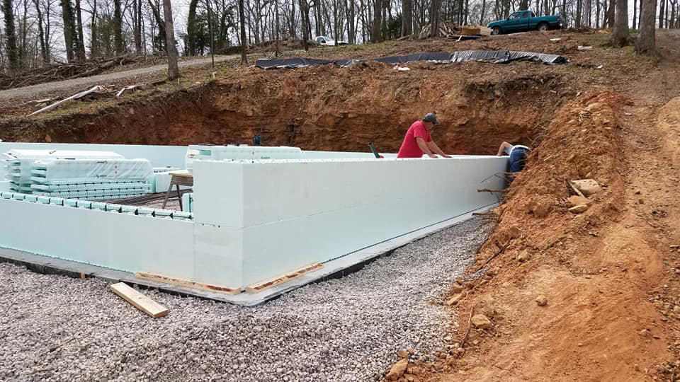 Workers installing insulated concrete forms for a new foundation at a job site by Central Enterprises in Clifton, IL.