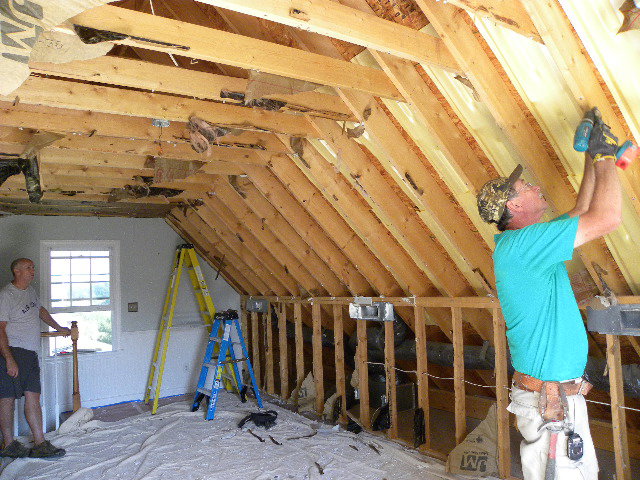 Workers installing insulation and framing in an attic during a renovation by B & L Builders in Jonesborough, TN