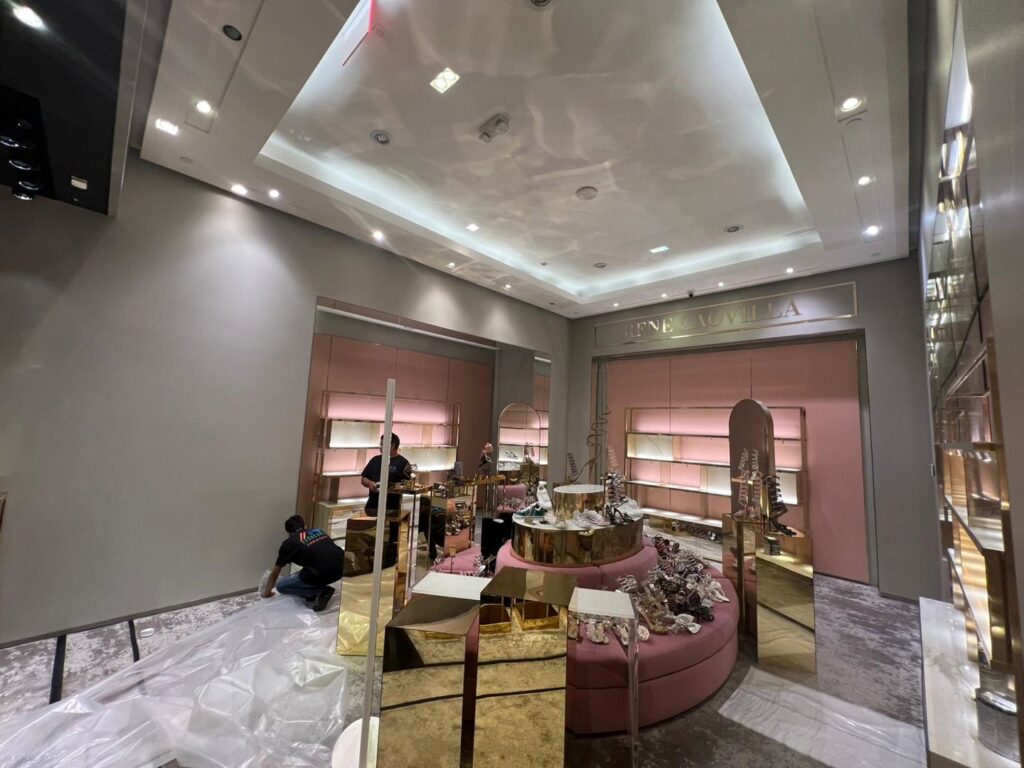 Workers installing new fixtures and shelving in a retail store for Vegas Valley Remodeling/Handy-Man Services in Las Vegas, NV.