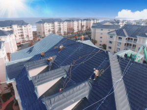 Workers installing a black roof membrane on a large commercial building for CAT 5 Contracting in Jacksonville, FL