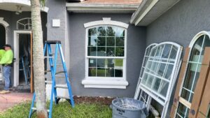 Construction workers installing new windows on a residential home by FHIA Remodeling in Fort Lauderdale, FL