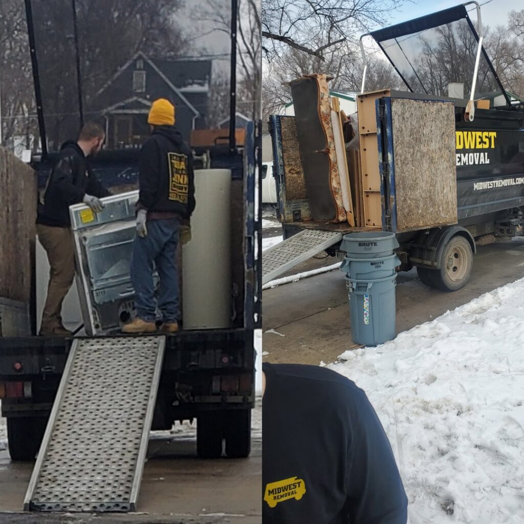 Midwest Removal workers loading a large appliance onto a truck ramp in a snowy environment in Omaha, NE.