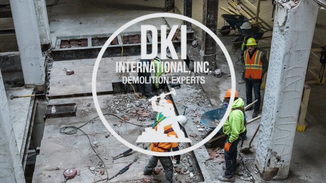 Workers actively performing demolition inside a commercial building for DKI Demolition in West Bloomfield Township, MI.