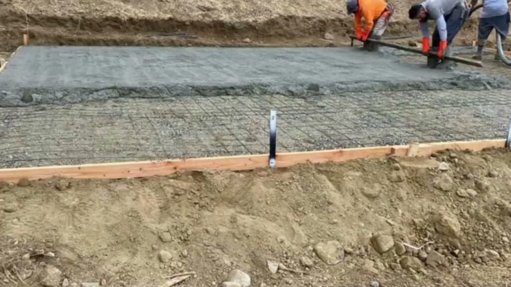 Workers pouring and leveling a concrete slab with rebar visible for Sal Handyman Services in Canyon Country, CA