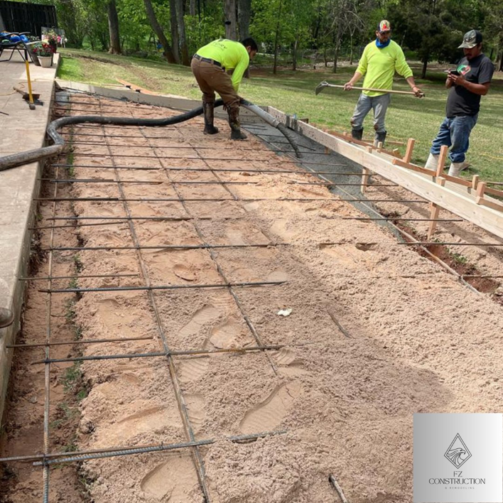 Workers pouring concrete for a new residential patio installation by FZ Construction in Everett, WA.