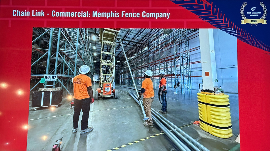 Workers preparing metal poles for commercial chain link fence installation in a warehouse by Memphis Fence Company, LLC in Memphis, TN.