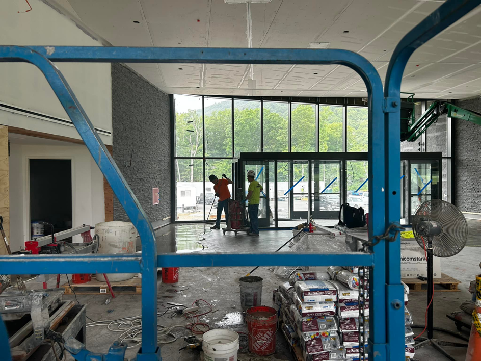 Workers preparing a floor for tile installation at a construction site by BRB Ceramic Tile & Marble in Metuchen, NJ