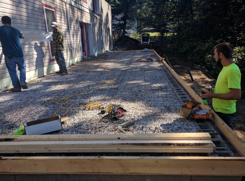 Workers from Detweiler Construction, LLC preparing a gravel base for a new patio or deck in Horse Cave, KY.