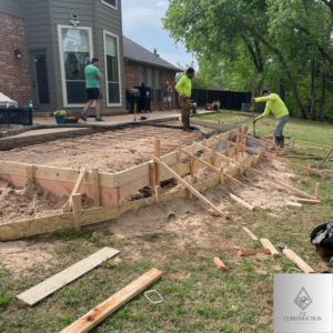 Workers preparing a residential concrete patio with rebar and forms for FZ Construction in Everett, WA.