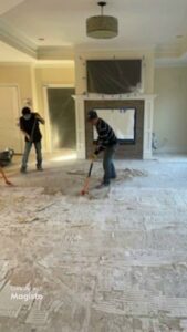 Workers removing old flooring and debris during a renovation project by Diamond Flooring LLC in Boston, MA