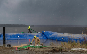 Workers performing shoreline construction in snowy conditions for Wilkinson Excavating, Inc. in Meadville, PA