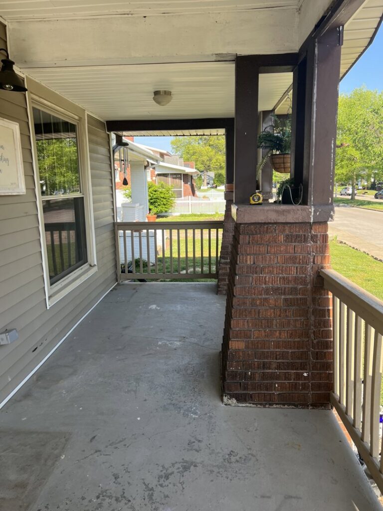 A worn front porch showing signs of wear, ready for a handyman coating service from Egli Coating Solutions in Evansville, IN.