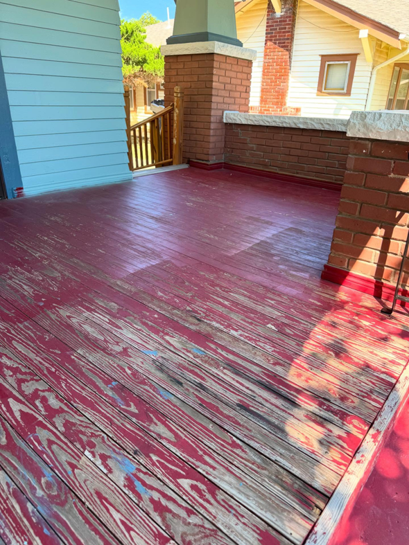 A worn porch floor with peeling red paint, showing the 'before' state of an exterior painting project by Pro Touch Painting Inc. in Oklahoma City, OK.