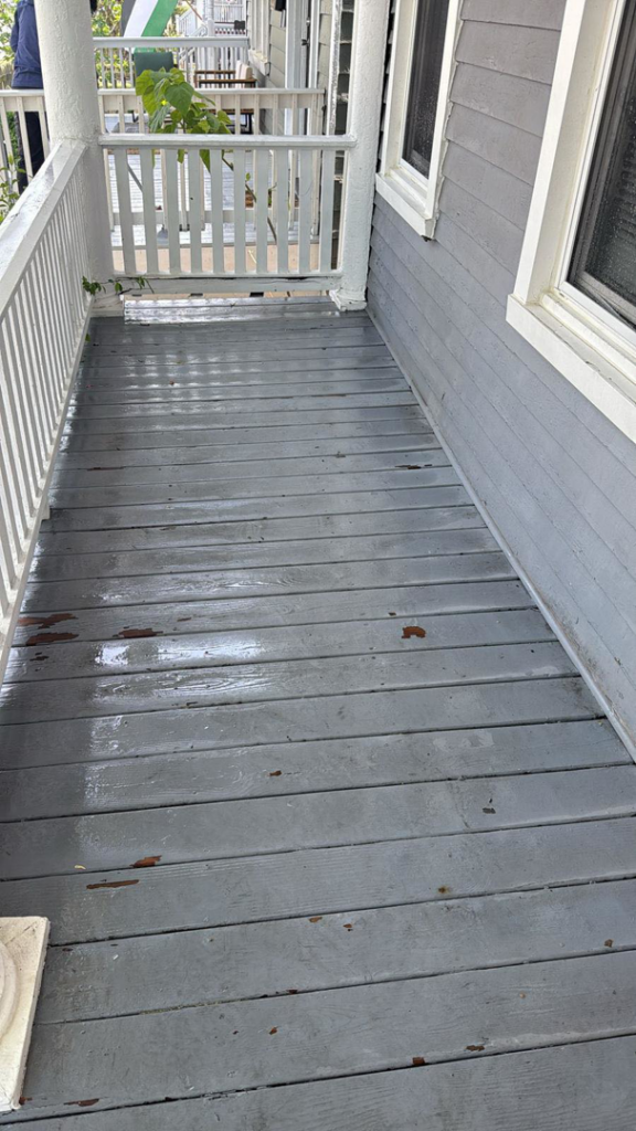 A worn wooden porch floor with peeling paint, ready for repair or refinishing by Isac's General Services LLC in Henrico, VA