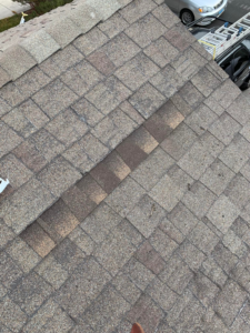 An asphalt shingle roof showing wear and tear, indicating a need for inspection and repair from Dan's "Do it All" Handyman Services in Reno, NV.