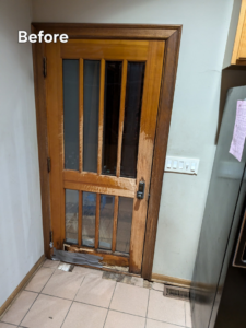 A worn wooden door with glass panels showing damage before repair or replacement by All Trades Home Improvement in Hobart, IN.