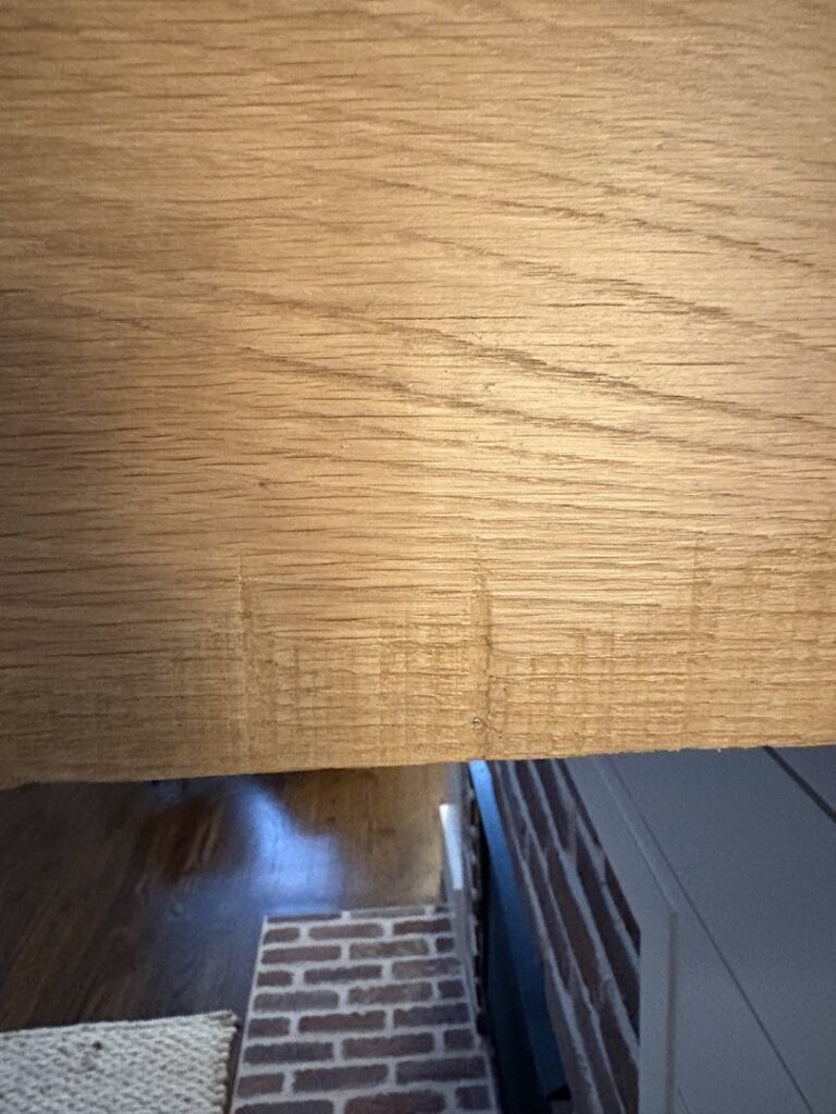 A close-up of a worn wooden floor or step edge, indicating a need for repair by Special Reserve Contracting in Charlotte, NC.