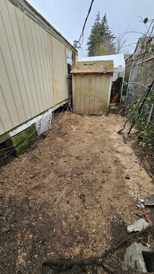A cleared yard area covered in sawdust after a tree stump removal and cleanup service by Can Do Andrew in Gresham, OR.