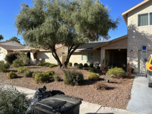 A front yard with landscaping debris and a ladder, showing yard cleanup services by Handyman Service's in North Las Vegas, NV.