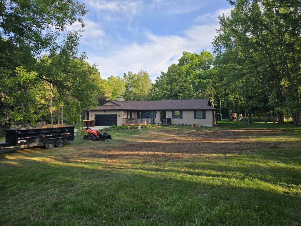 A residential yard cleared after tree removal by Father and Son Tree Service in Lansing, MI.