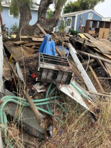 A large pile of mixed yard debris, wood, and general junk awaiting removal by Gabriel's Hauling & Junk Removal Services in San Diego, CA.