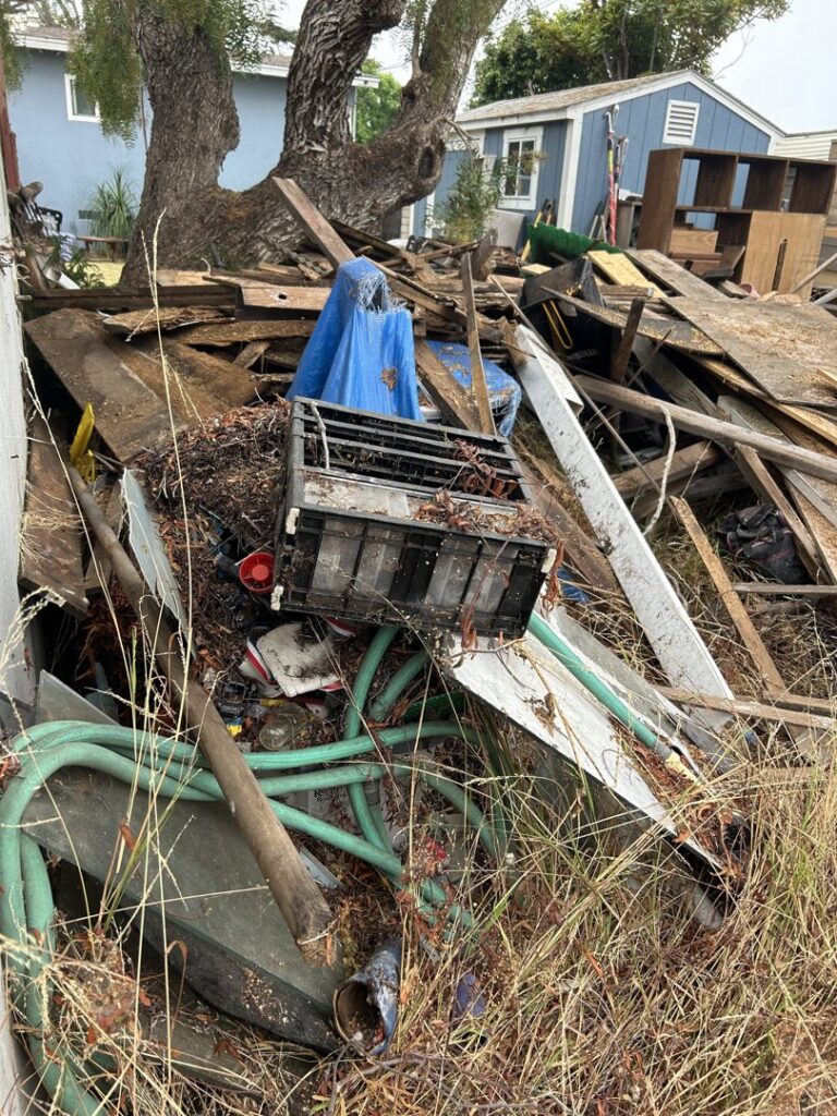A large pile of mixed yard debris, wood, and general junk awaiting removal by Gabriel's Hauling & Junk Removal Services in San Diego, CA.