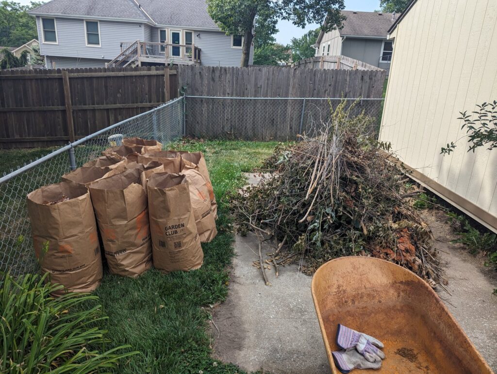 A large pile of yard waste and paper bags ready for removal by Rubbish Boyz Removal LLC in Independence, MO.
