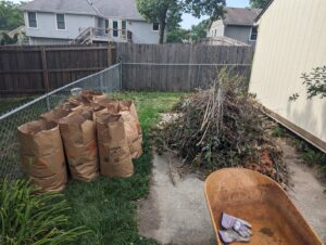A large pile of yard waste and paper bags ready for removal by Rubbish Boyz Removal LLC in Independence, MO.