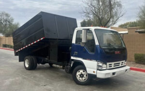 A blue and white junk removal truck used by YEE-HAul Trash Removal in St. George, UT.